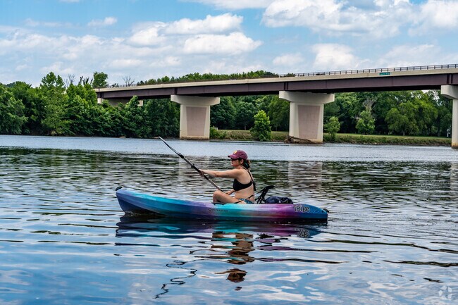 Kayaker paddles by the Huguenot Bridge at Huguenot Flatwater Park in Southhampton neighborhood