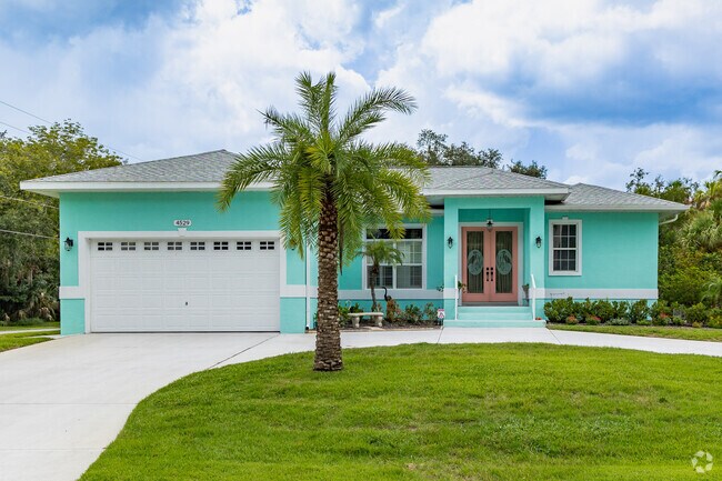 See brightly colored ranch homes with tropical landscaping in Homosassa.