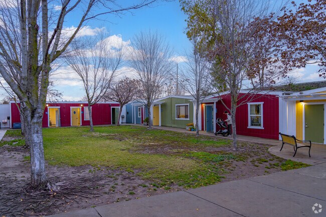 Colorful buildings line the grass area of Courtyard Private School.