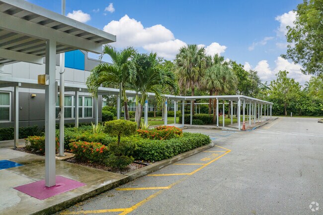 Crosspointe Elementary School drop off area surrounded by palm trees.