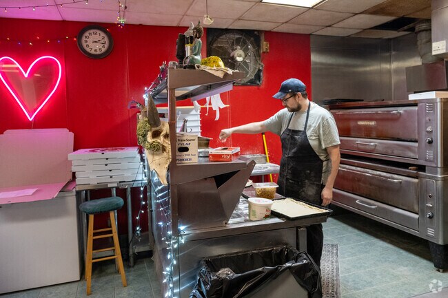 The cooks make a pizza at Frankie's Worcester Best Pizza.