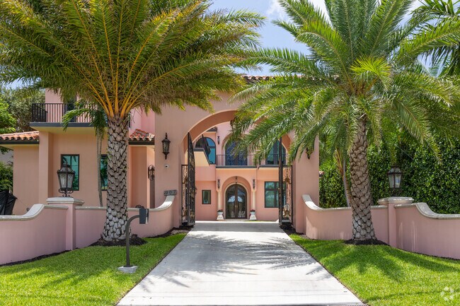Mediterranean style gated family home in South Palm Beach neighborhood.