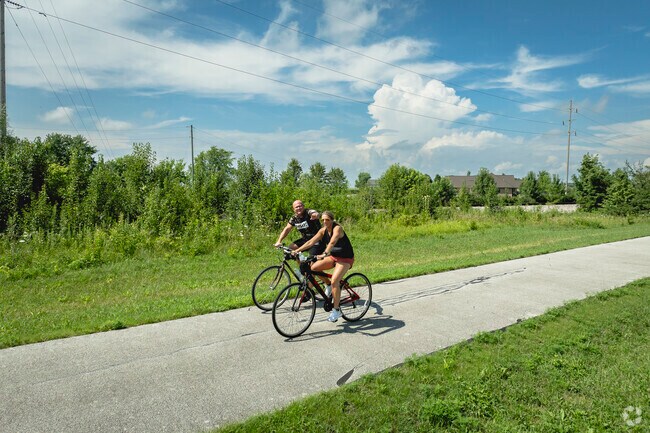 Cyclists ride the Celina CW Bikeway on a sunny day in Coldwater.