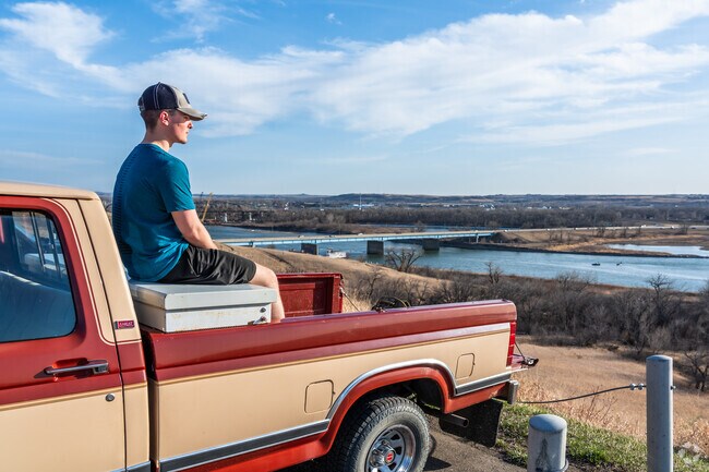 Residents park to watch sunsets near Sonali Garden in Country West.