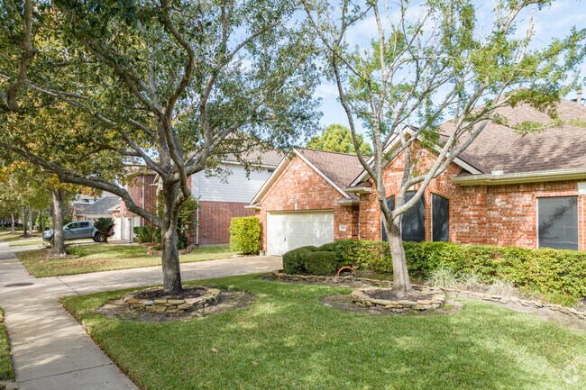 Front yards in Stone Gate are covered with beautiful trees and lush greenery.