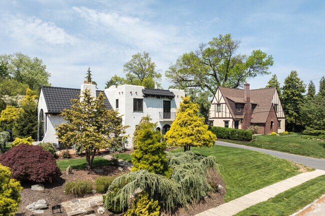 In Elmwood, diverse home styles feature a Santa Fe Pueblo Revival house beside an English Tudor.