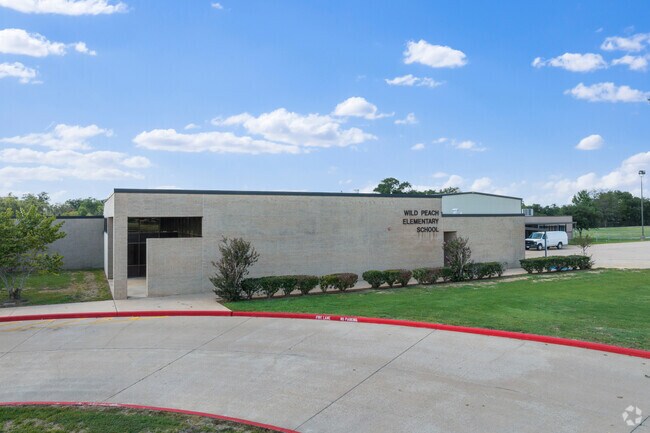 The school was built in 2006 and is named after the wild peach trees that were nearby.