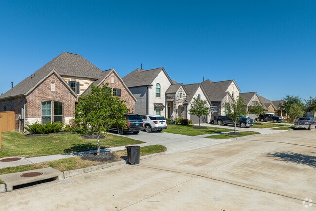 A row of Tuscany inspired homes sits along a quiet street in the Tuscan Lakes area.