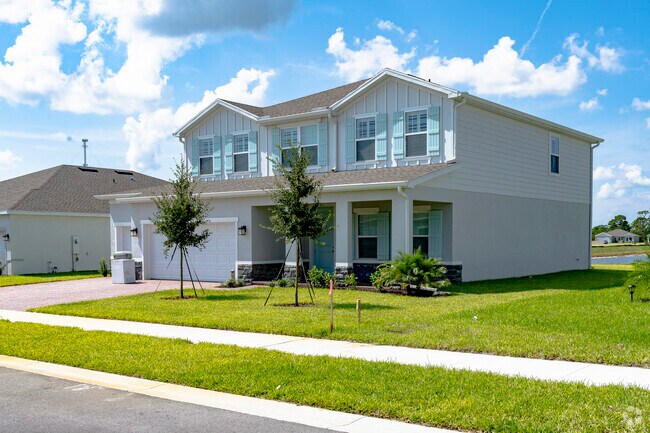 This two-story Winter Beach residence boasts an inviting front porch.
