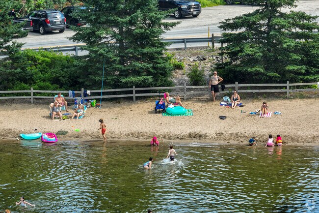 Families enjoy the sandy beach at the Foot of Mousam Lake in Acton.