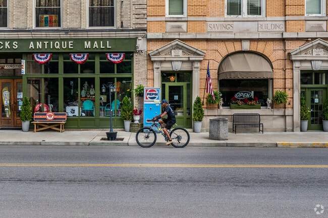 A cyclist rides past Slacks Antique Mall in Wellsville.