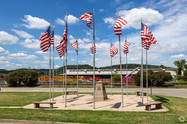 Cross Lanes locals observe flags waving at a memorial honoring fallen soldiers.