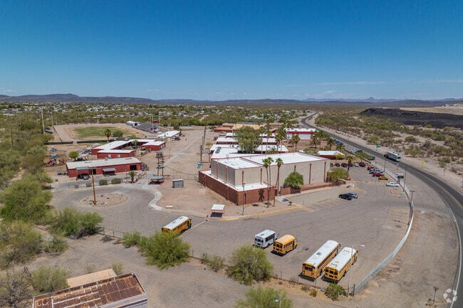 A wider view of Ajo's shared school campus shows both elementary and high school facilities, along with bus access and administrative buildings nestled in the desert landscape.