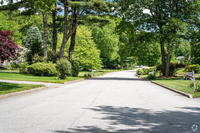 Locals enjoy a leisurely stroll through the lush green neighborhoods of Shippeetown, RI.