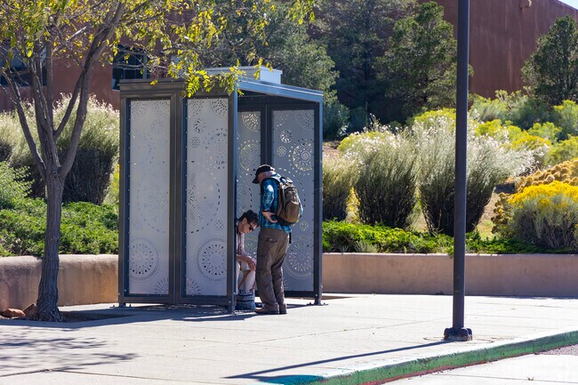 A couple waits for the bus near Museum Hill in Southeast.