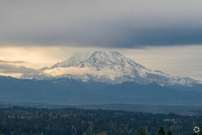 Mount Rainier peeking out of the clouds over Fife Heights.