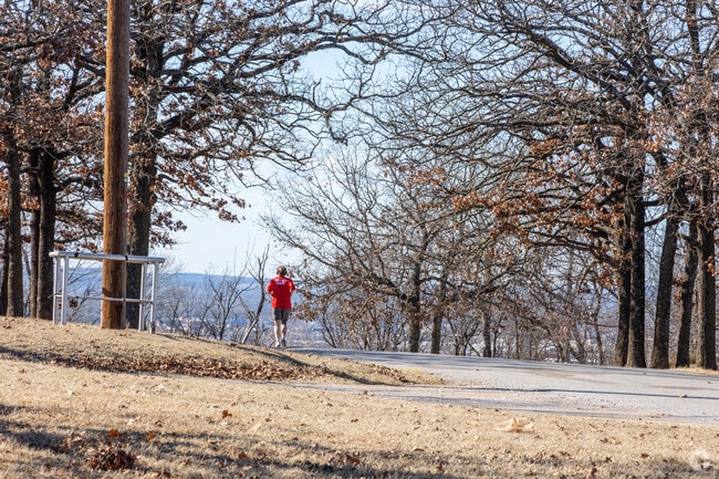 Healthy residents of Sand Springs jog the paths of Chandler Park near Sand Springs.