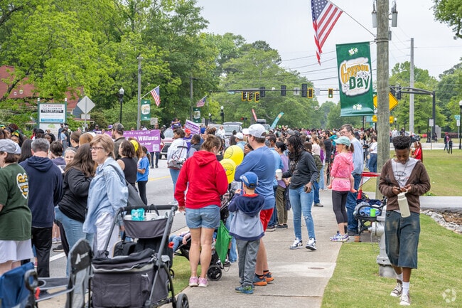 Hundred. of local residents line the streets of downtown for the annual Grayson Day.