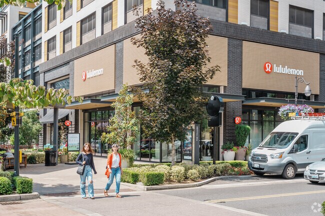 Shoppers walk from store to store in The Village at Totem Lake.