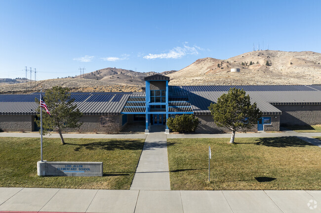 An aerial view of Lois Allen Elementary School with mountains in the background.