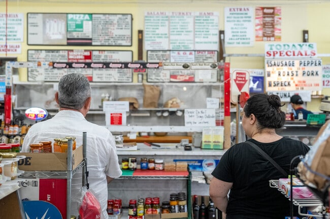 The deli counter at Mario's is always bustling, offering an impressive selection of meats, cheeses, and sandwiches.
