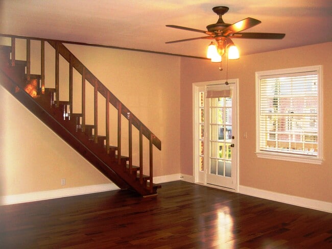 Living room with the door to the patio and stairs to the loft /master bedroom