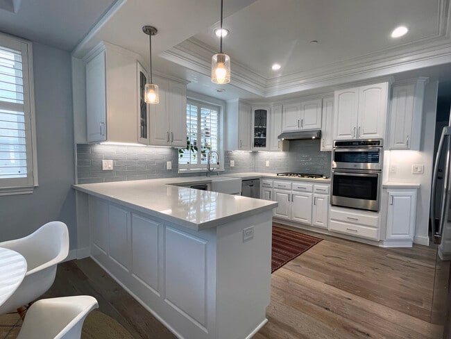 High End Kitchen with garden window, granite countertop, high end appliances and plenty of storage