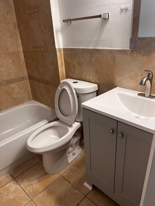 Floor to Ceiling Ceramic Tile Bathroom
