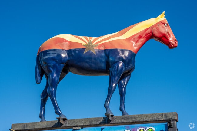 This colorful, Arizona flag themed horse can be found as you approach Desert Mountain.