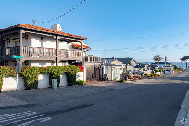 Golden hour illuminates the row of homes, creating a picturesque path to Cayucos Beach.
