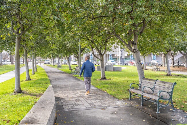 A man takes a stroll down the trail at Guadalupe River Park.