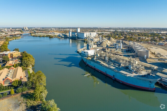 A large ship docking along the San Joaquin river at Seaport.