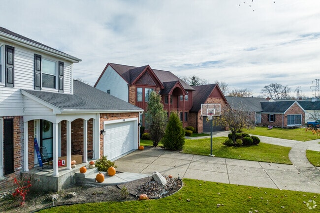 A row of diverse homes in Amherst has well manicured lawns and spacious driveways.