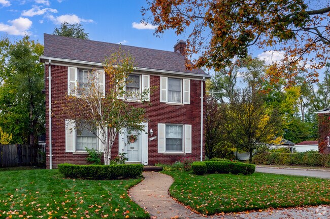 Brick colonial home with a manicured lawn in Schulze, Detroit.