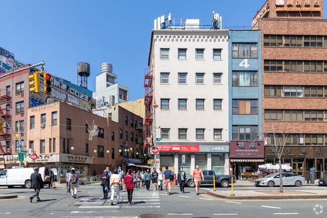 Bowery Street is one of Chinatowns busiest streets as commuters & cars get around.