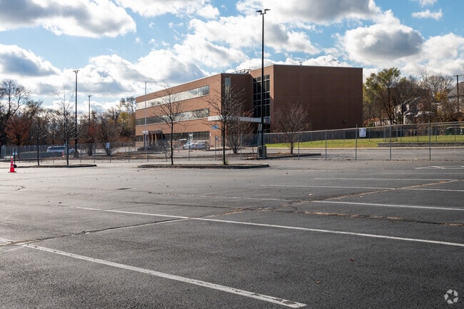 A large parking lot next to AF Iluminar Middle School in Providence.