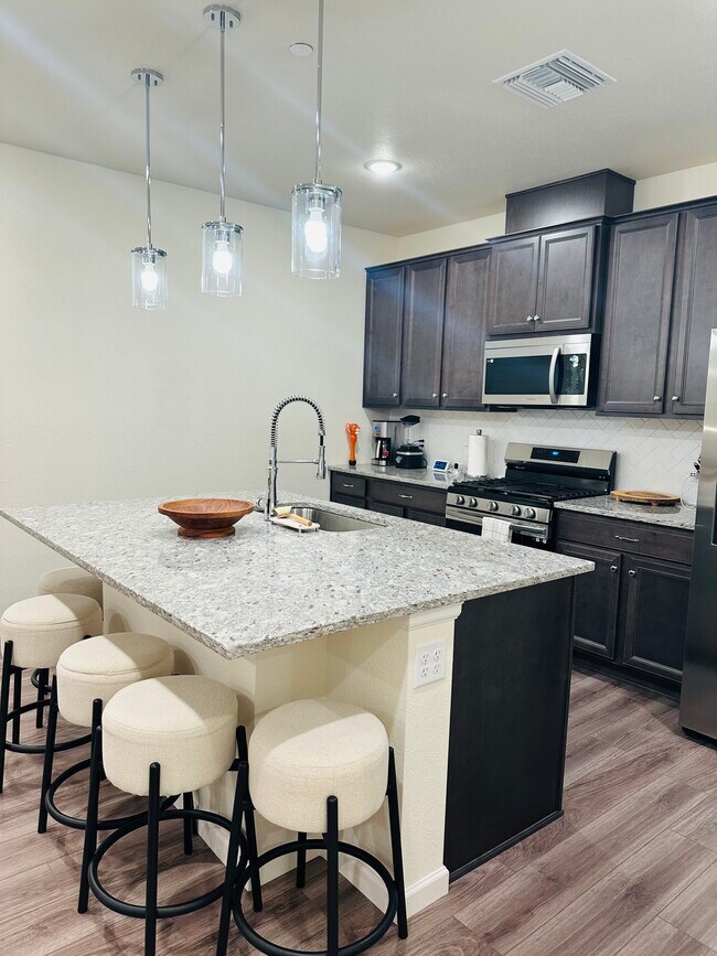 Spacious kitchen with gas range and stainless steel appliances