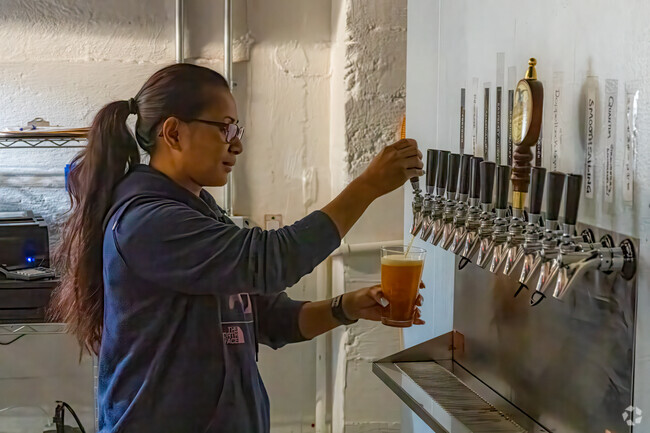 The bartender at Helicon Brewery's tap house pours one of their excellent beers in McDonald.