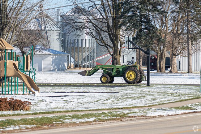 Farmers can be seen working with their tractors in rural village of Lisbon, IL.