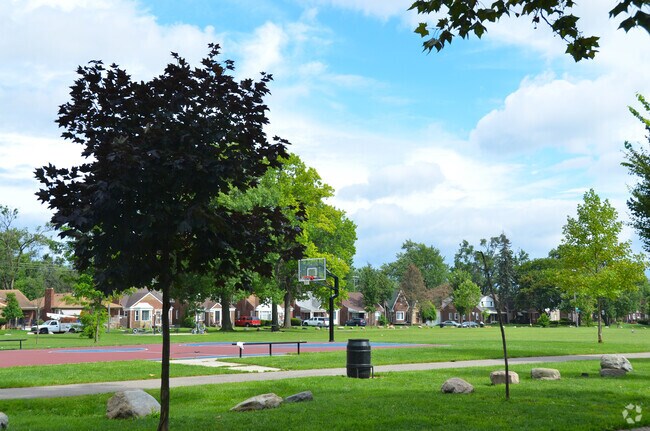 The basketball court in Diack Park is surrounded by green spaces.