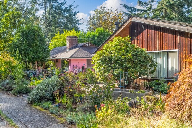 Some Briarcrest homes are dwarfed by giant evergreen trees and lush yards.