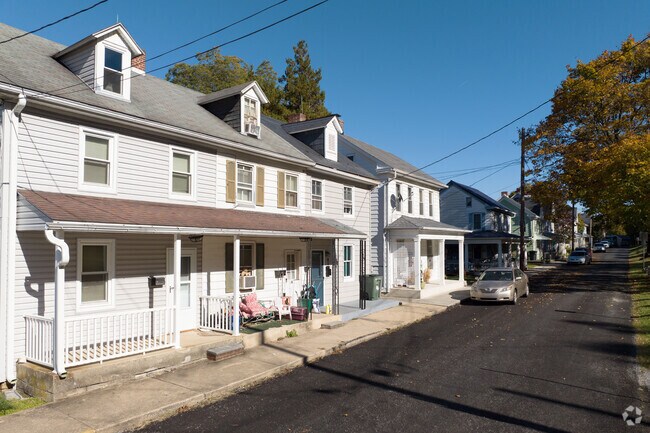 Dormer windows protrude from classic colonials in Yoe.