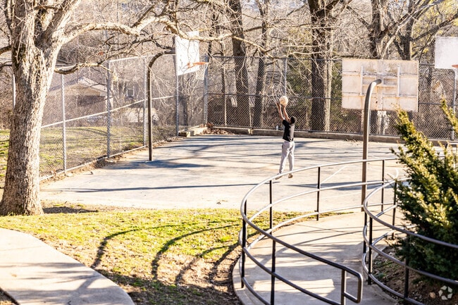 Residents shoot hoops at Oakwood Park’s outdoor courts in Talbot’s Corner.