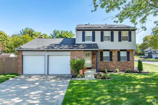 A foursquare home in Smoky Ridge Estates features a well-manicured front yard.
