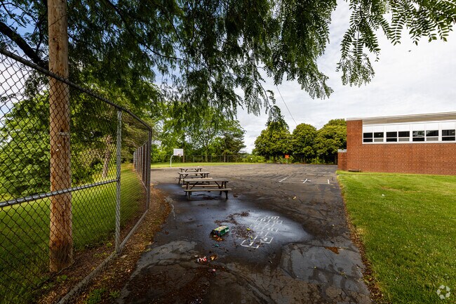 Clara Barton has a large play area in the rear with basketball so the kids can play.
