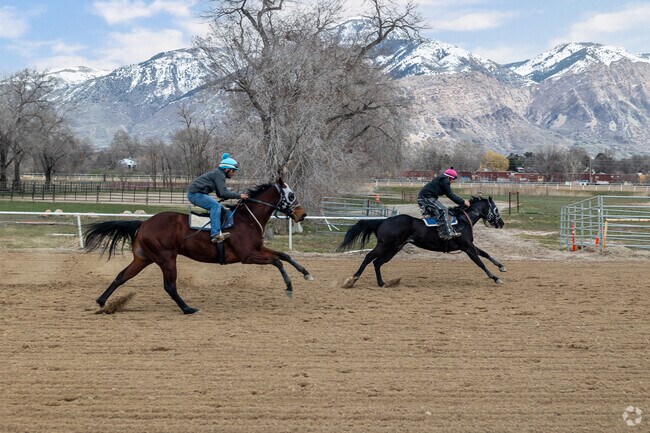 Riders race horses at Golden Spike Event Center in Harrisville.