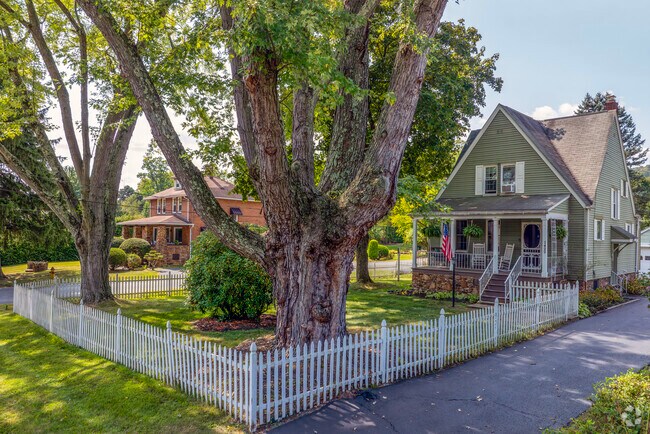 Expanses of open land with tall pine and oak trees line the neighborhood's roads.