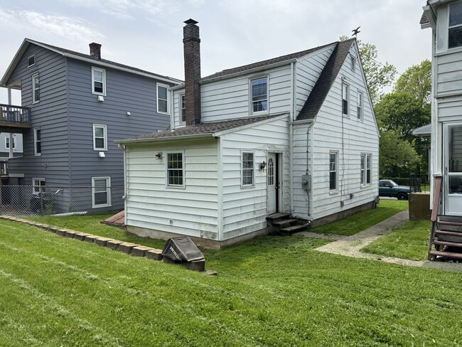 Back of house with level yard