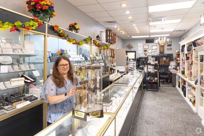 A friendly shopkeeper greets customers in Weston.