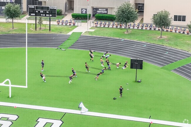 Students at Keller High School practice for upcoming football games.